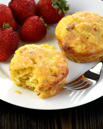Frittata Muffins on a plate with fork and berries.