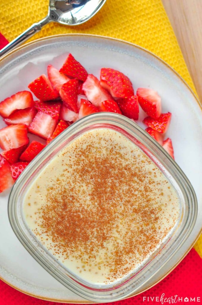 Overhead view of Quinoa Pudding with side of fresh strawberries.