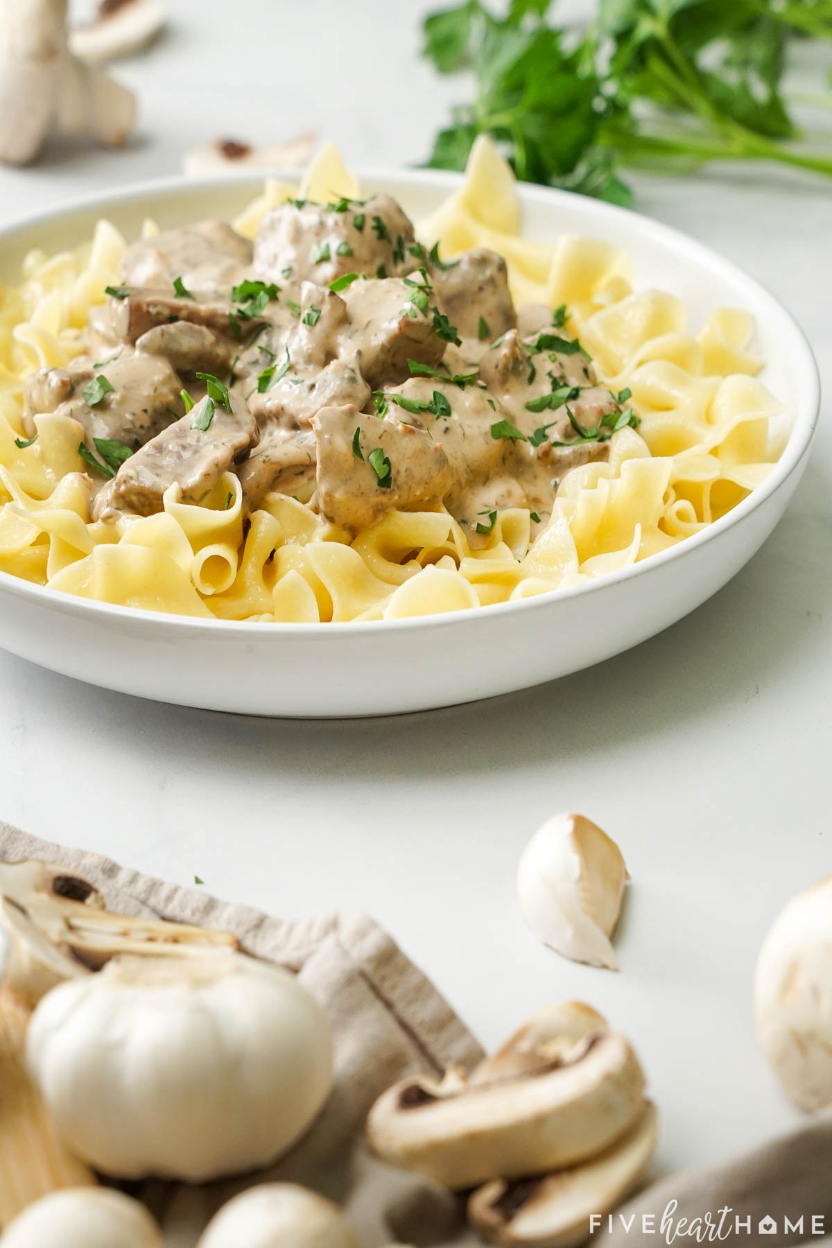 Crock Pot Beef Stroganoff with mushrooms on table.