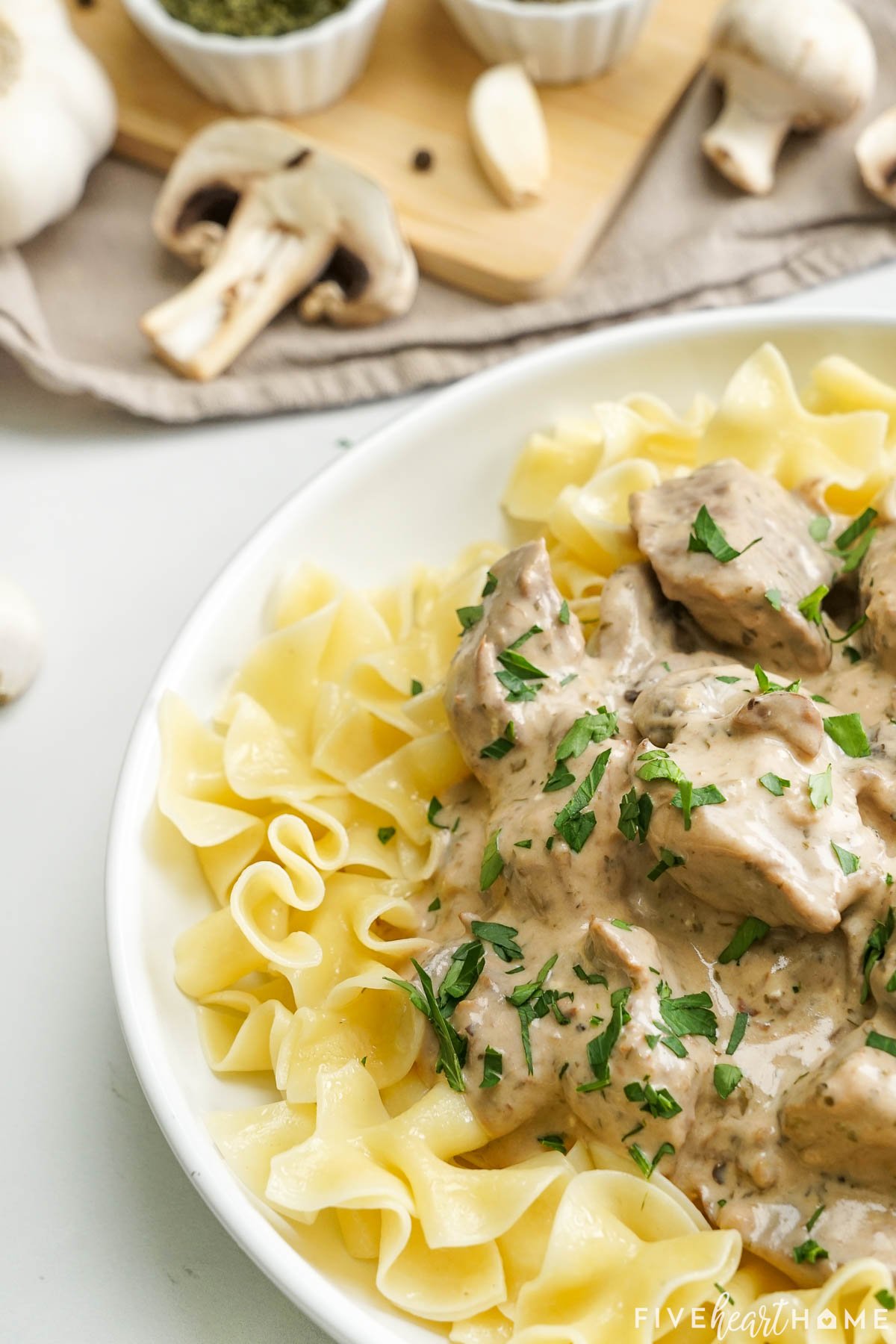 Close-up of Crock Pot Beef Stroganoff over noodles.