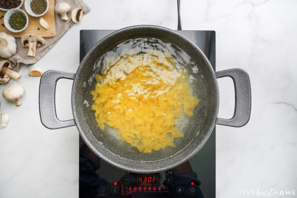 Egg noodles boiling on stove.