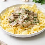 Crock Pot Beef Stroganoff in shallow white bowl.