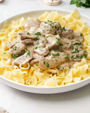 Crock Pot Beef Stroganoff in shallow white bowl.