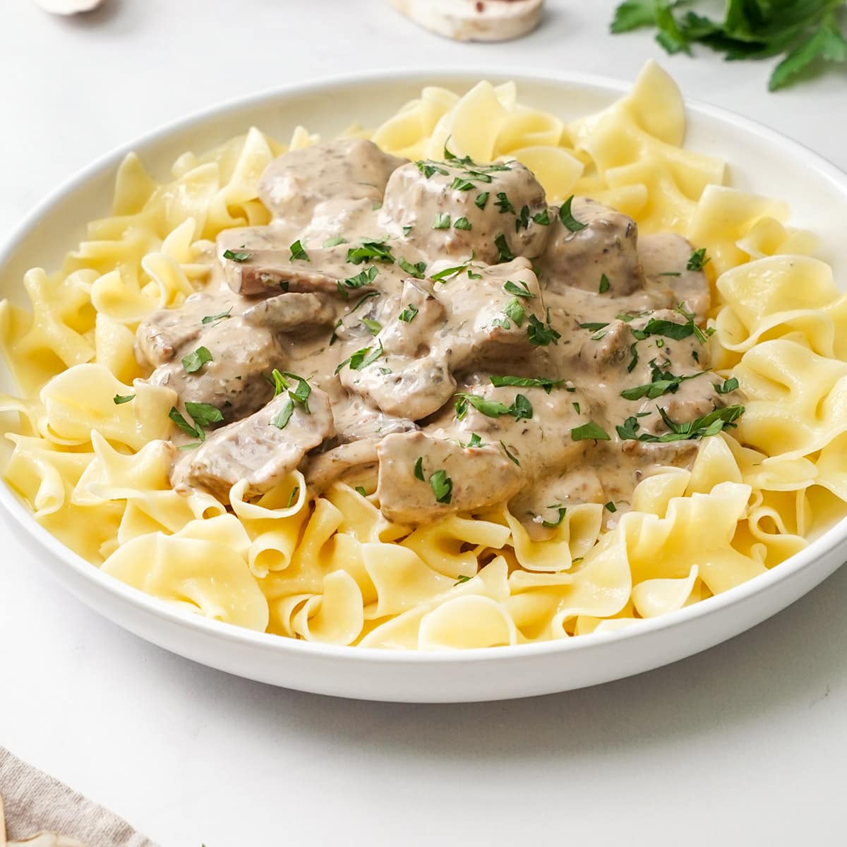 Crock Pot Beef Stroganoff in shallow white bowl.