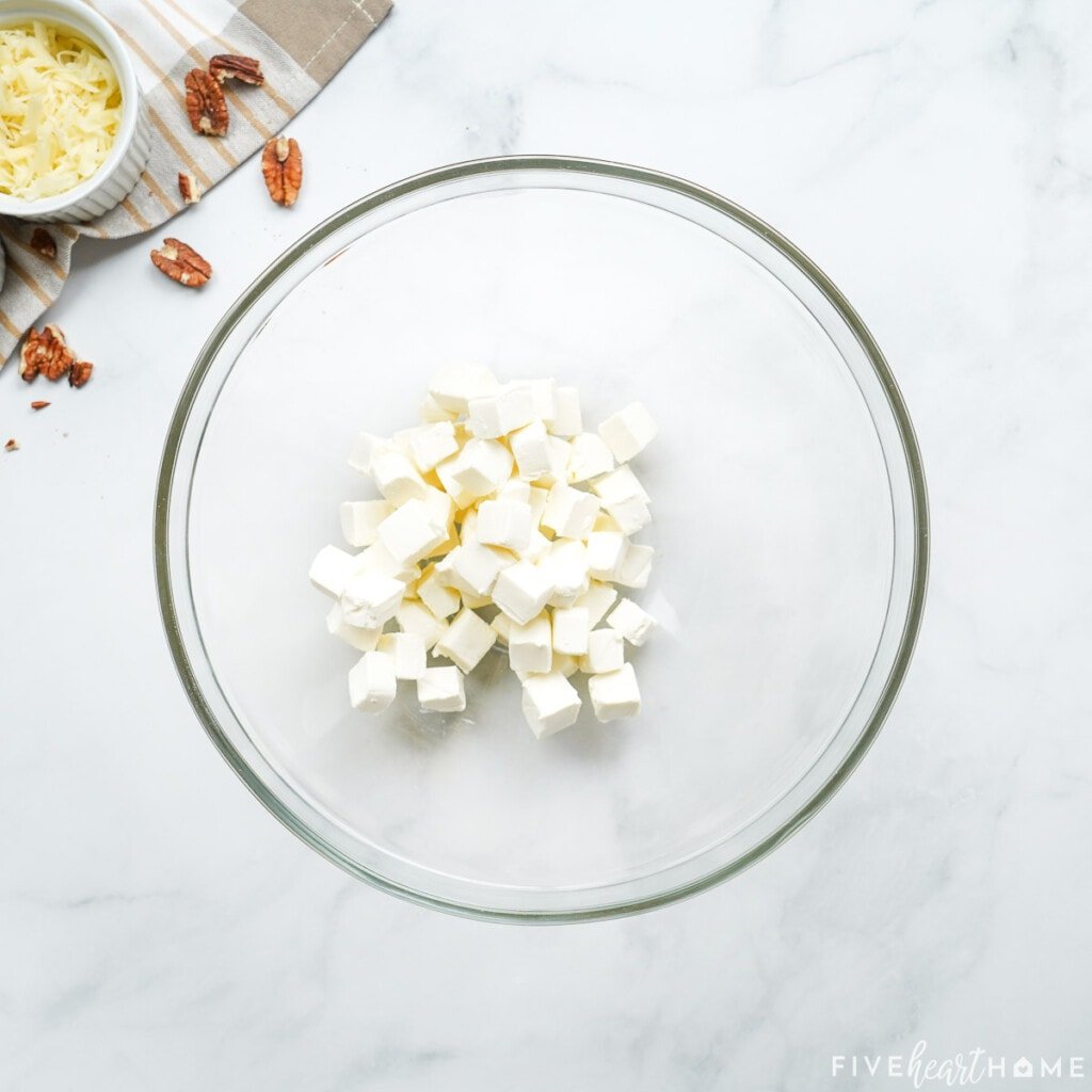 Cubed cream cheese in bowl.