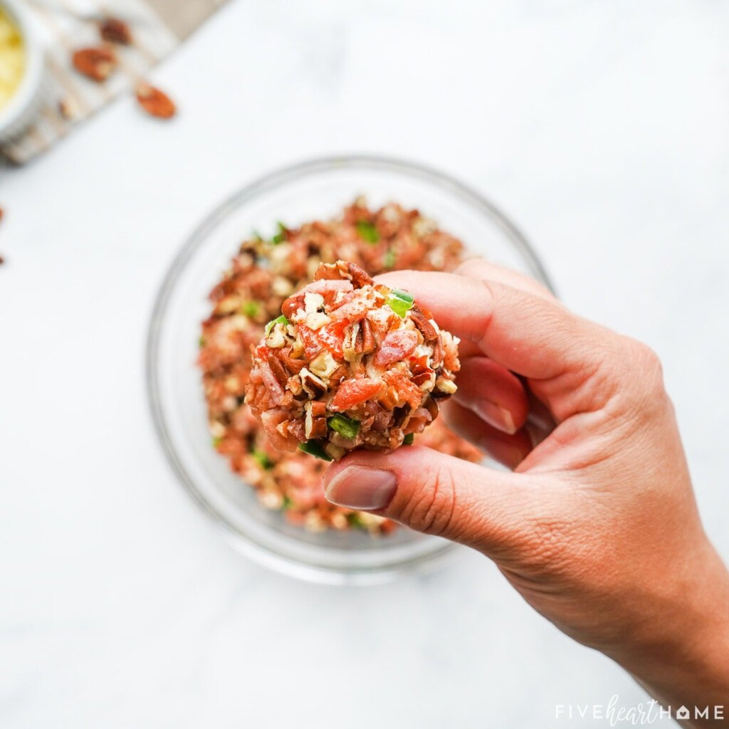 Rolling pimento cheese ball in coating.