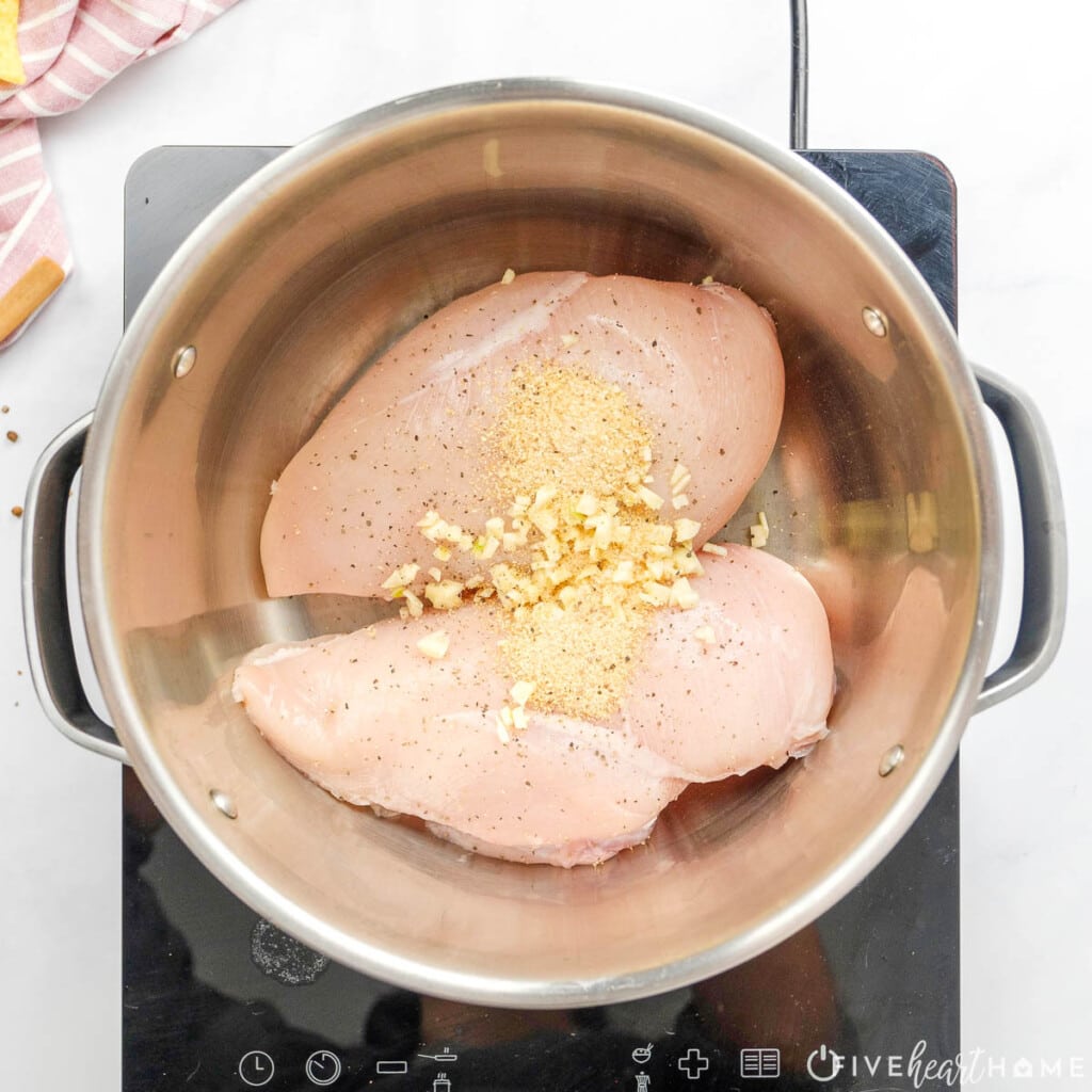 Adding garlic and spices to pot.