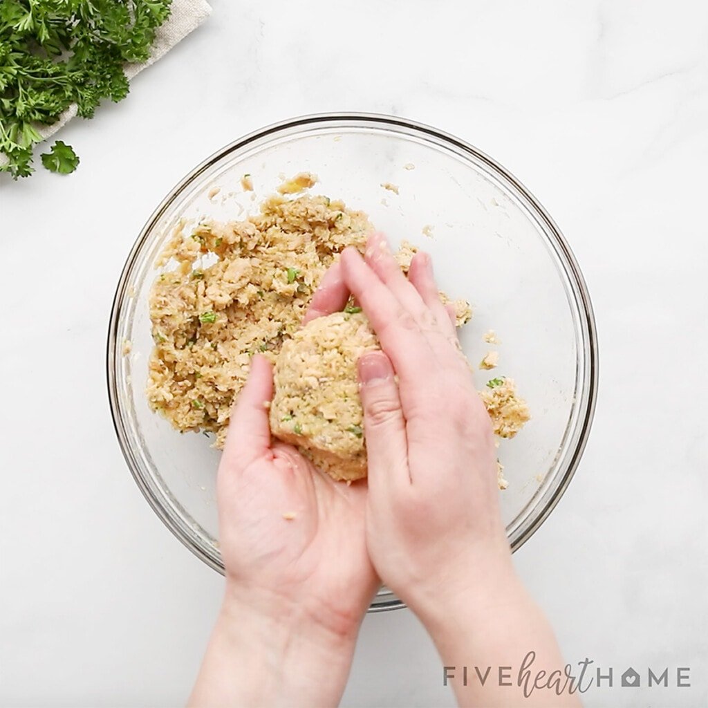 Forming mixture into salmon croquettes.