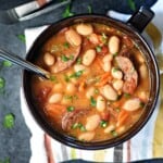 Aerial view of Cajun Bean Soup in bowl with spoon.