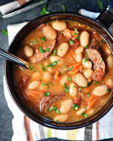Aerial view of Cajun Bean Soup in bowl with spoon.