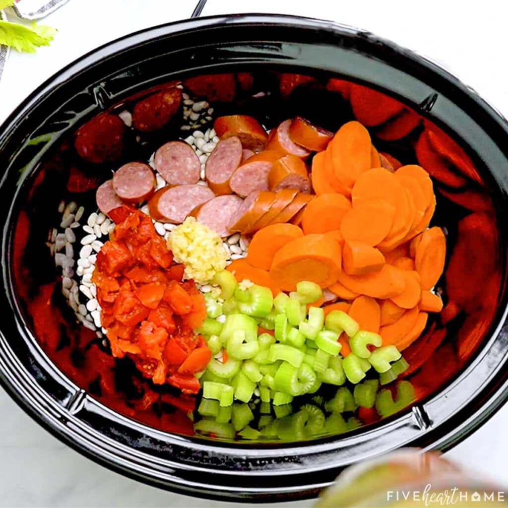 Ingredients in crockpot for Cajun bean soup recipe.