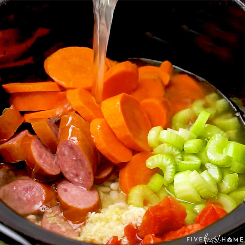 Adding broth to slow cooker.