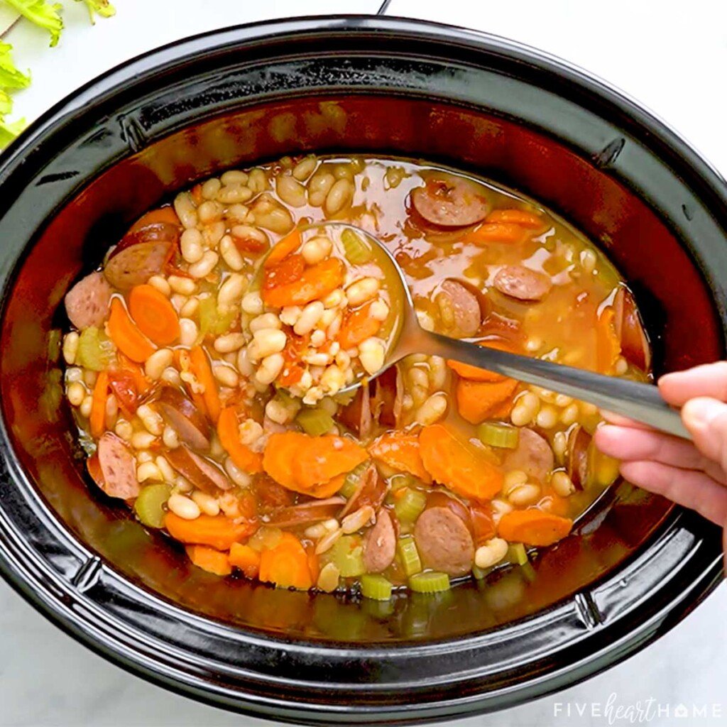 Cajun Bean Soup being ladled from slow cooker.