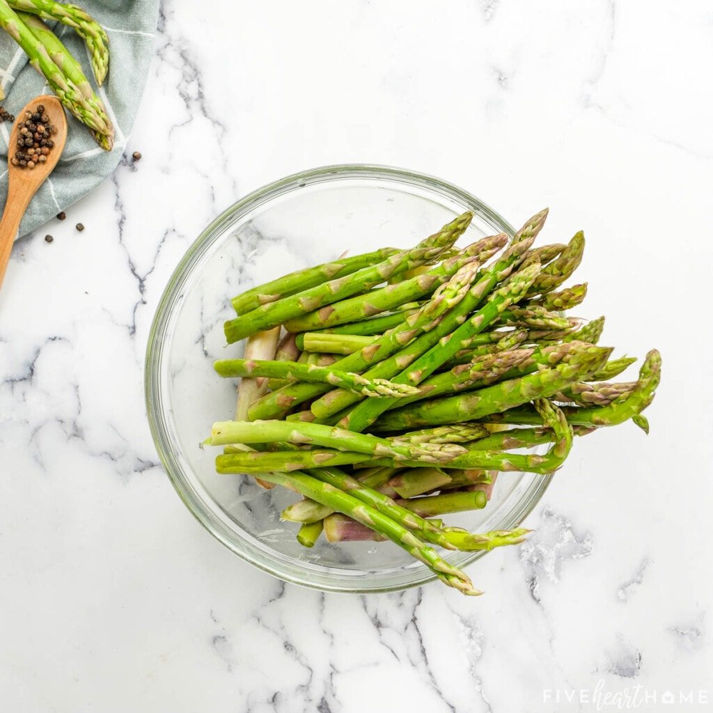 Fresh asparagus spears in a bowl.