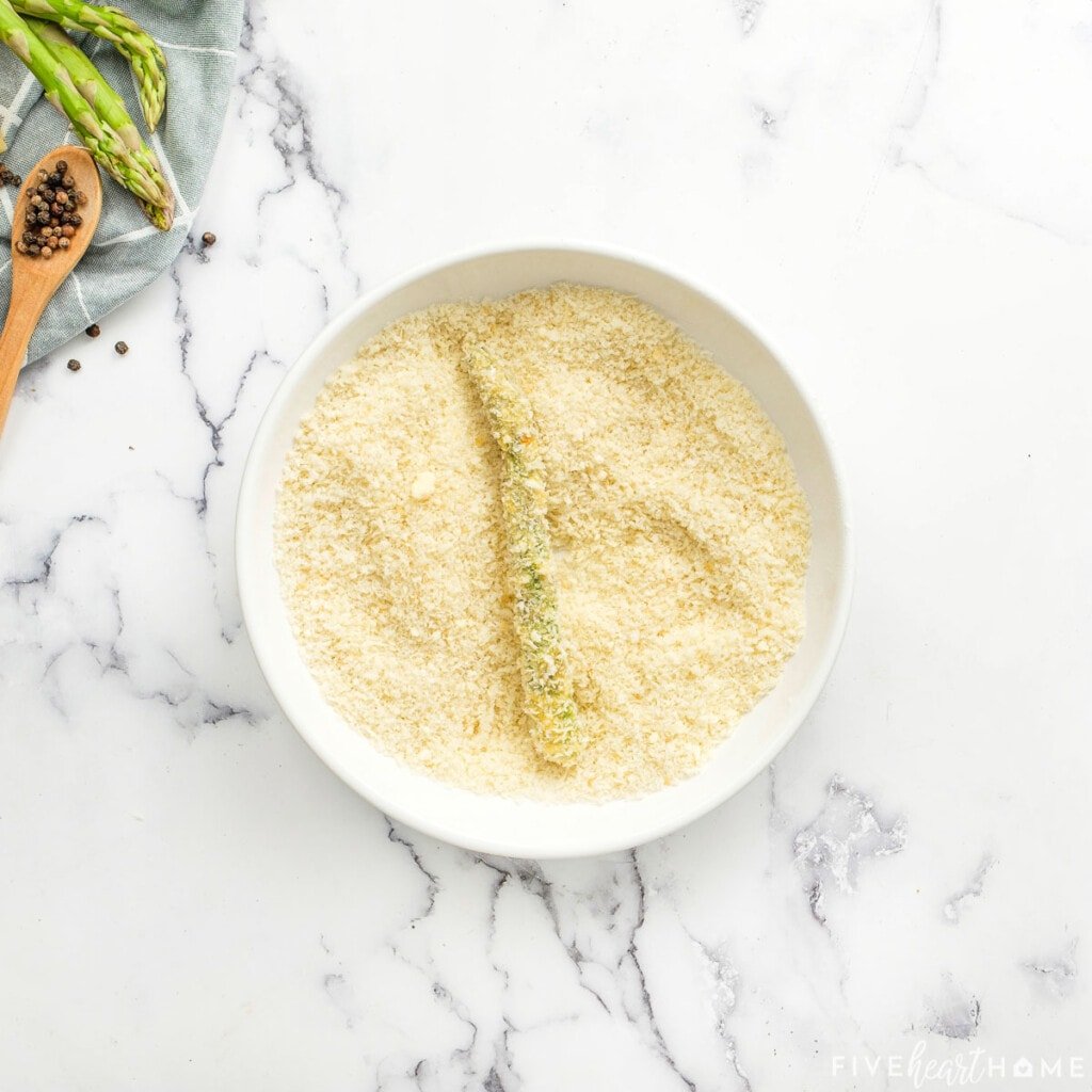 Parmesan crusted asparagus in bowl with Panko.