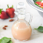 Blush Wine Vinaigrette with spinach and strawberries in background.