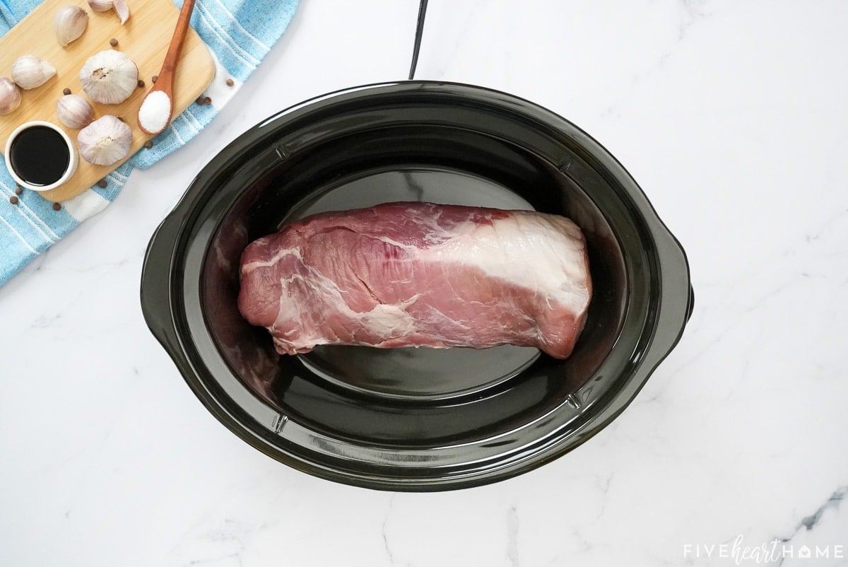 Aerial view of pork loin in crock pot.