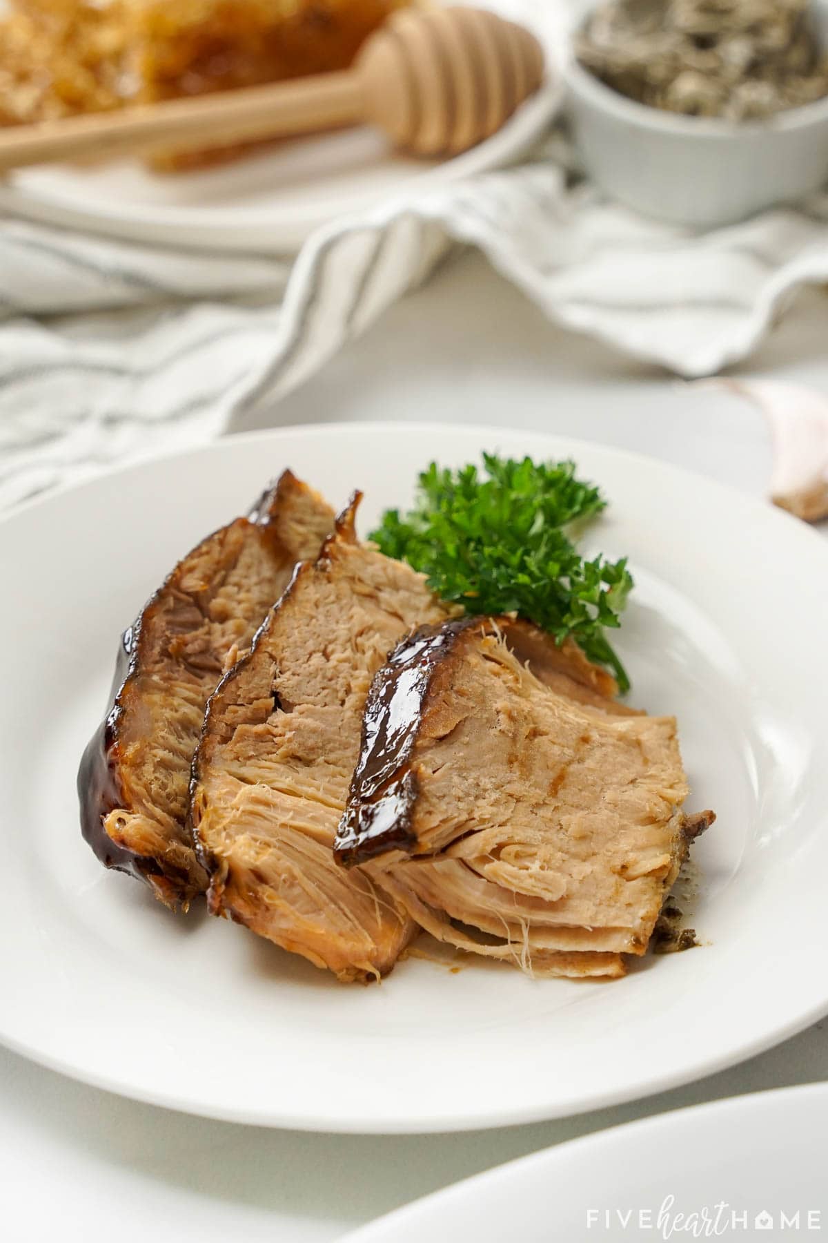 Crock Pot Pork Loin on plate with honey balsamic glaze.