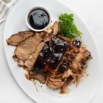 Crock Pot Pork Loin with balsamic glaze on platter.