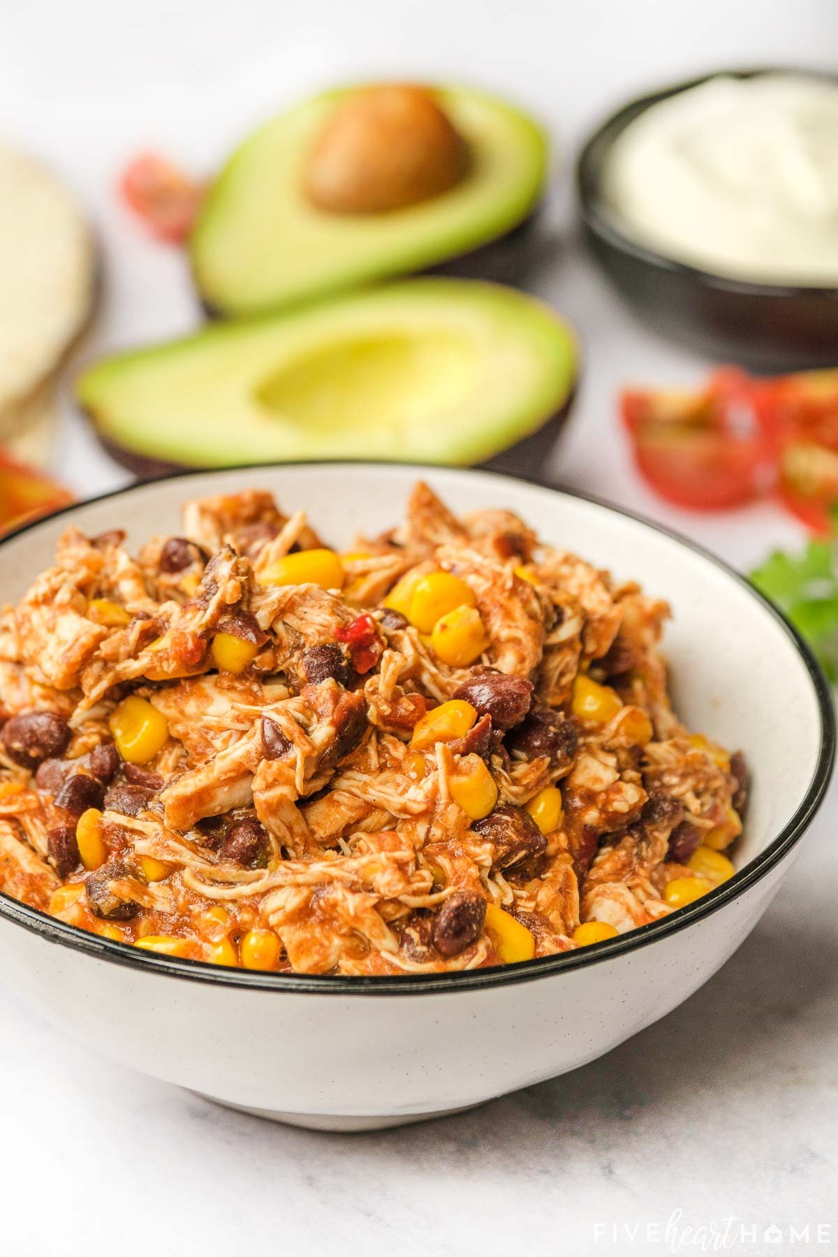 Slow cooker chicken tacos filling in white bowl.