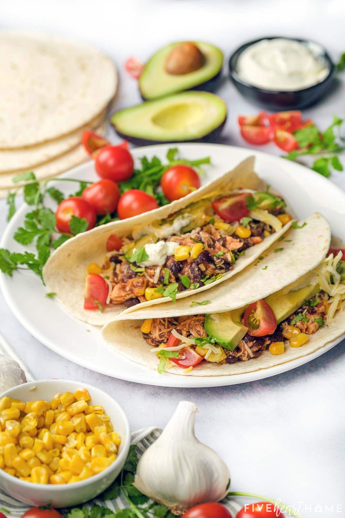 Crockpot Shredded Chicken Tacos on flour tortillas.