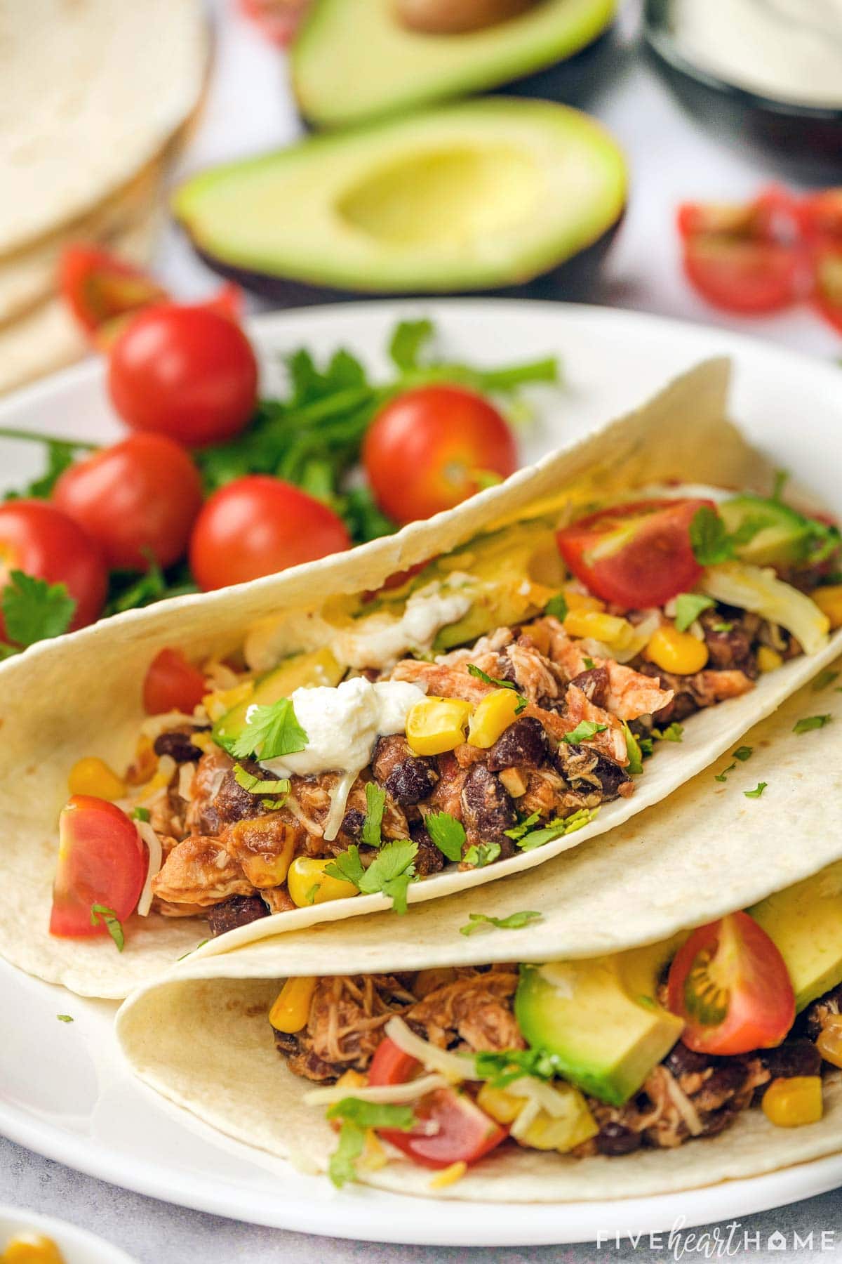 Close-up of Crockpot Shredded Chicken Tacos made with salsa and taco seasoning.