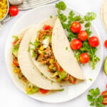 Aeriel view of Crockpot Shredded Chicken Tacos on white plate.