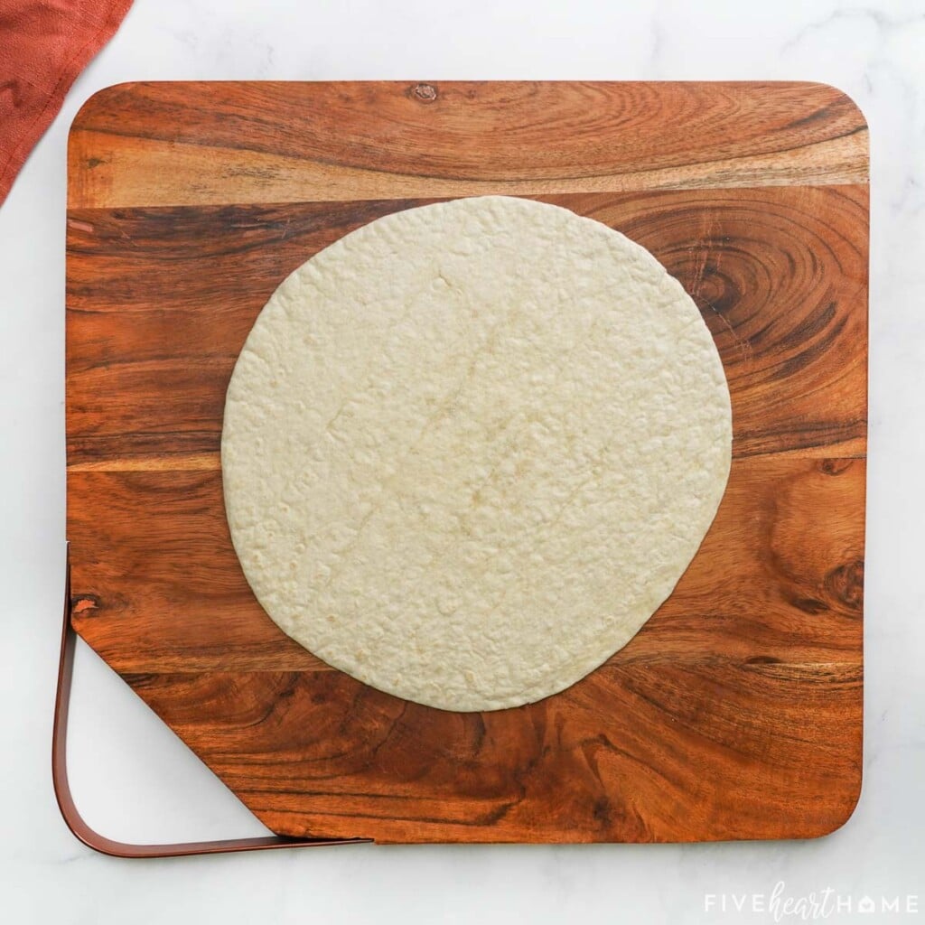 Flour tortilla on wooden board.