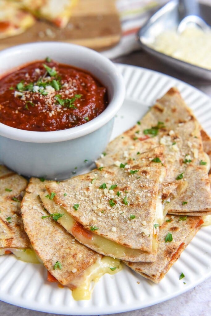 Pizza Quesadillas on plate with pizza sauce for dipping.