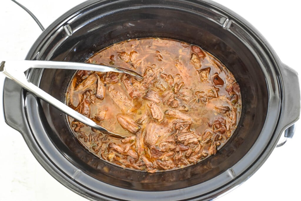 Crock Pot Tacos Shredded Beef in slow cooker.