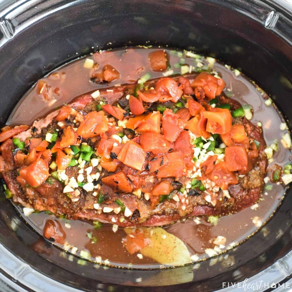 Slow cooker full of Crockpot Shredded Beef for Tacos.