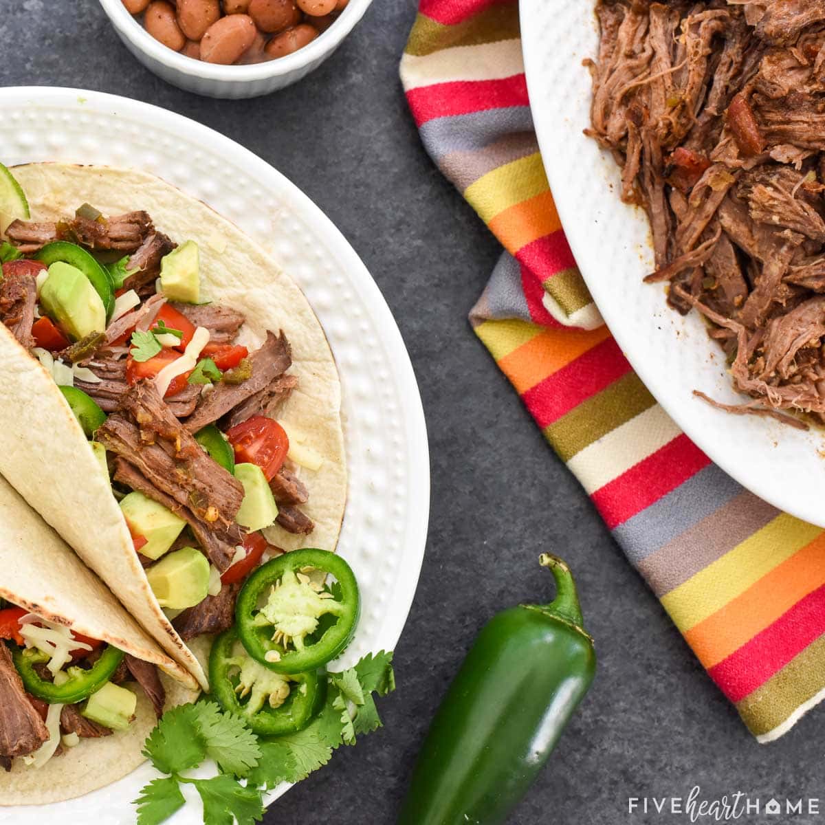 Shredded Beef Tacos Crock Pot on platter and plate of tacos.