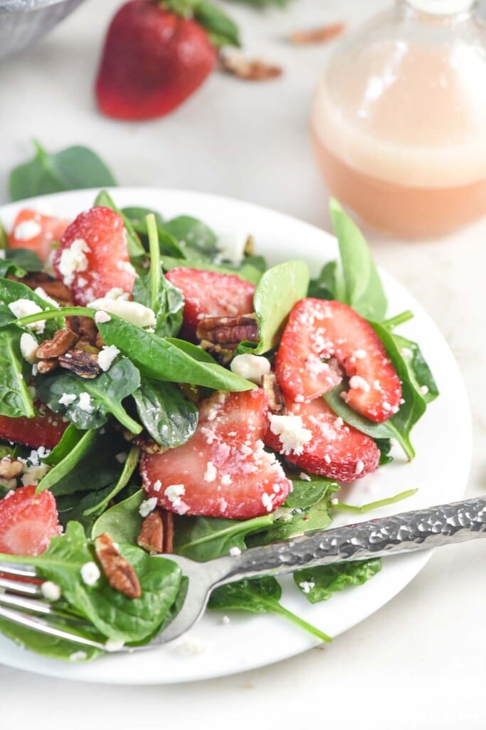 Spinach Salad with Strawberries on white plate.