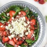 Spinach Salad with Strawberries topped with toasted pecans, feta, and blush wine vinaigrette.