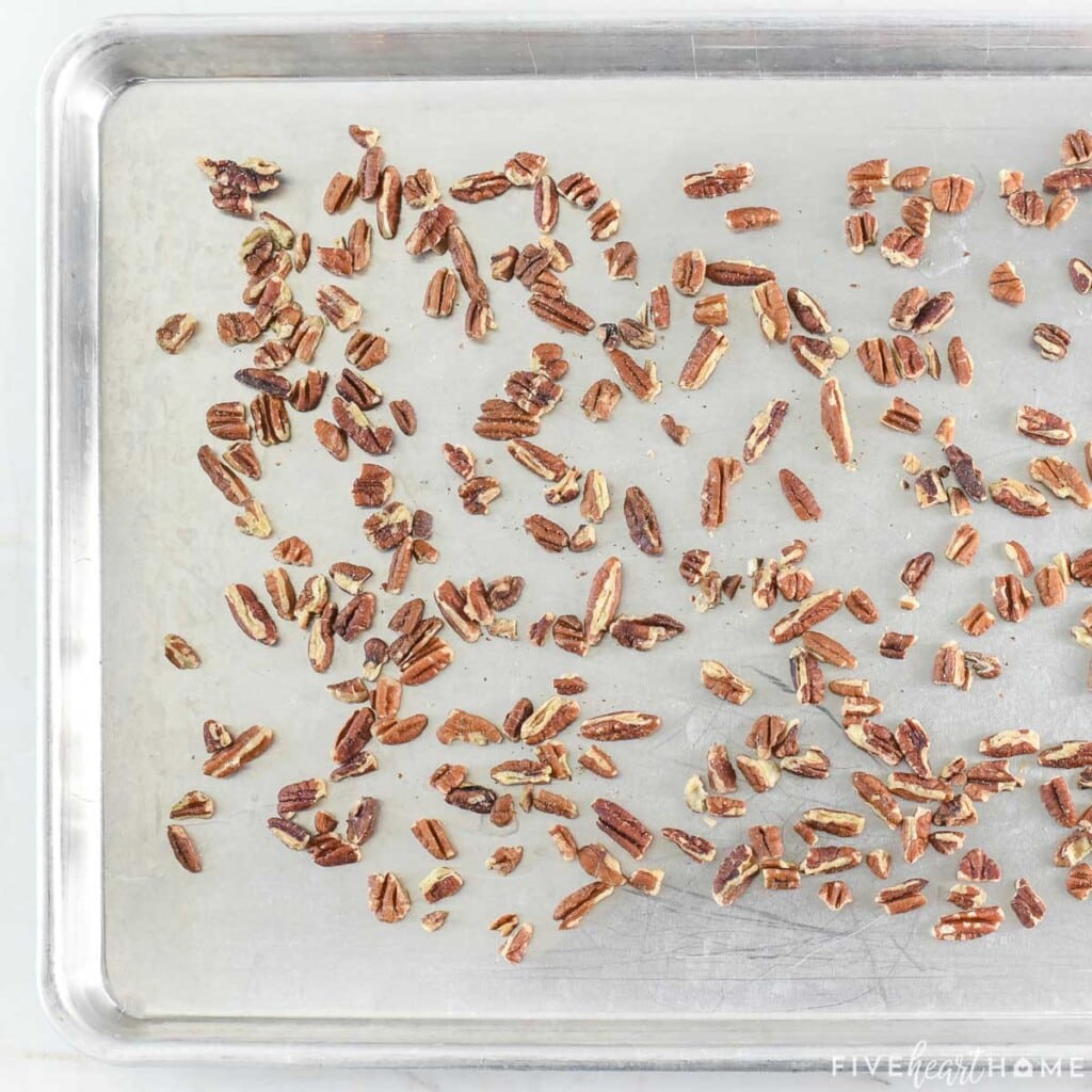 Chopped pecans on baking sheet.