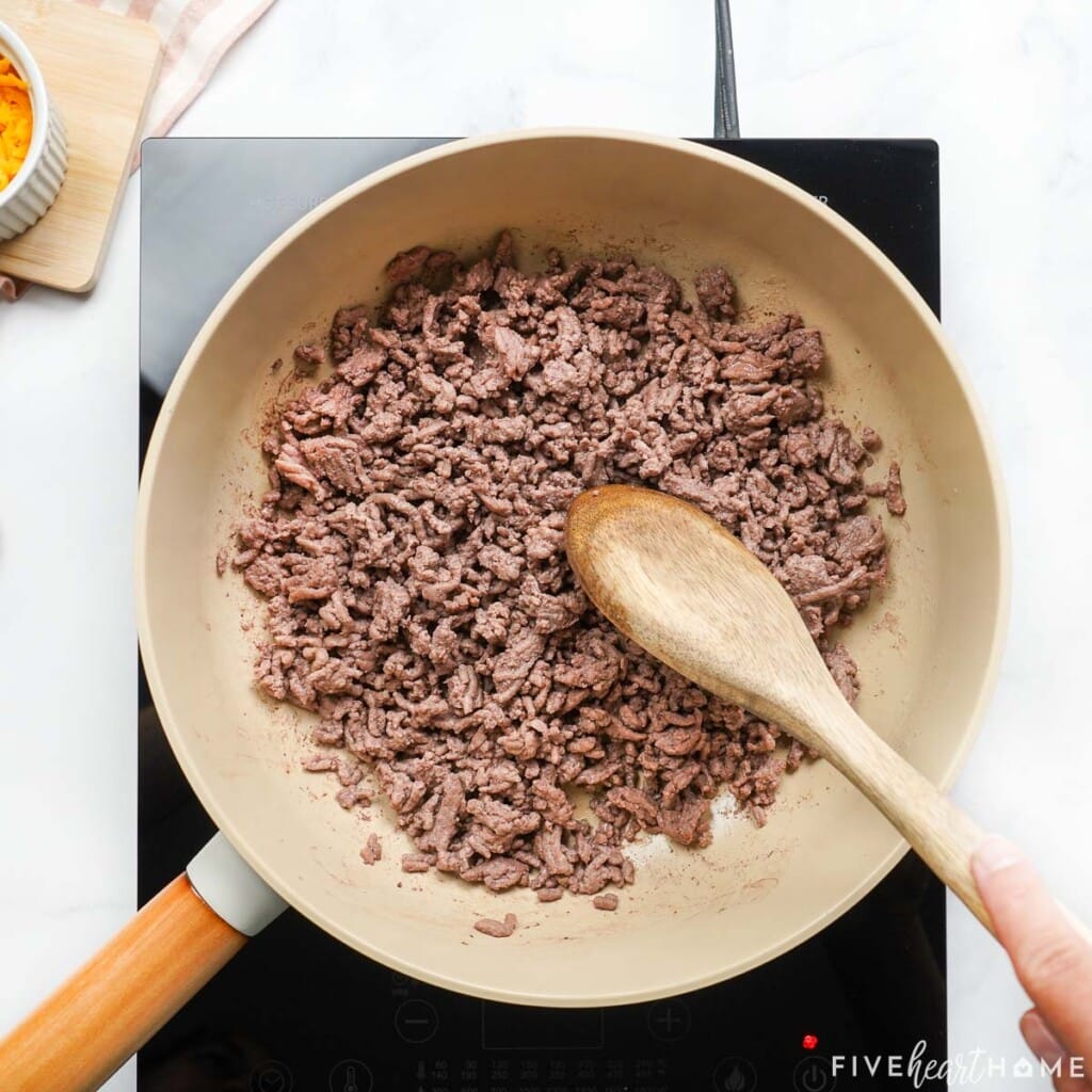 Browning ground beef in skillet.