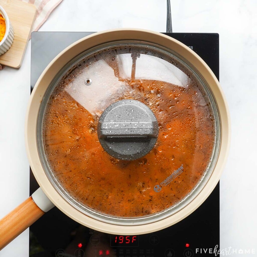 Lid on skillet of Taco Hamburger Helper recipe.