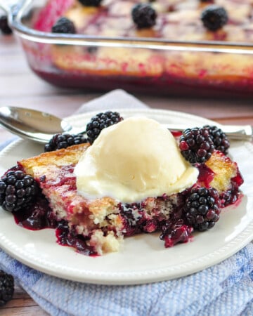 Blackberry Cobbler in dish and on plate with scoop of ice cream.