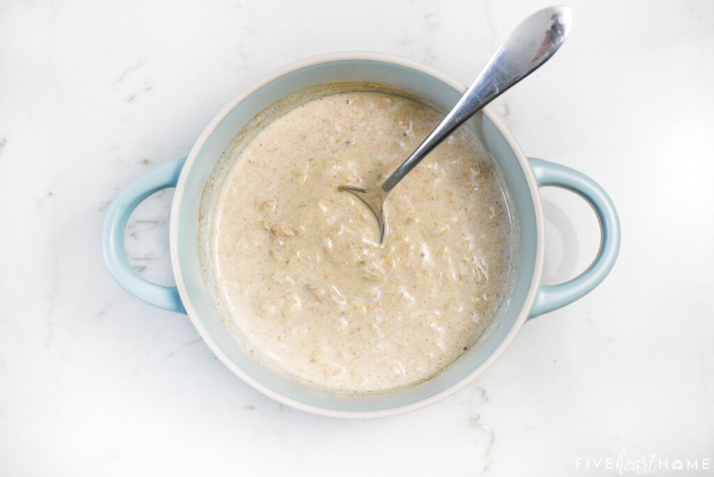 Overnight oats recipe peanut butter stirred together in bowl.