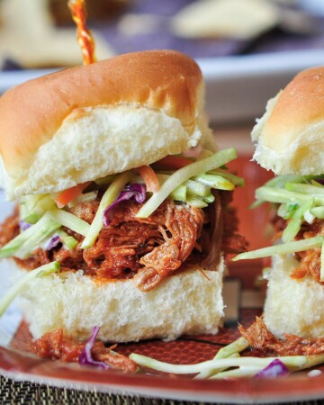 Root Beer Pulled Pork recipe served on buns with slaw.