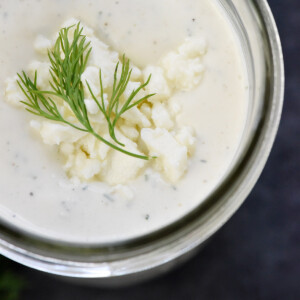 Close-up of Feta Dressing with fresh dill and crumbled feta on top.