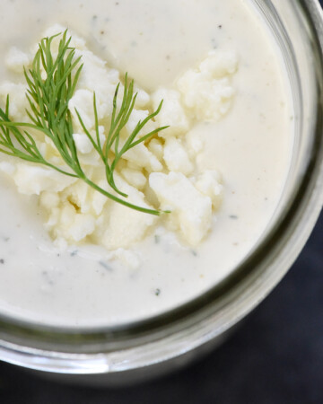 Close-up of Feta Dressing with fresh dill and crumbled feta on top.