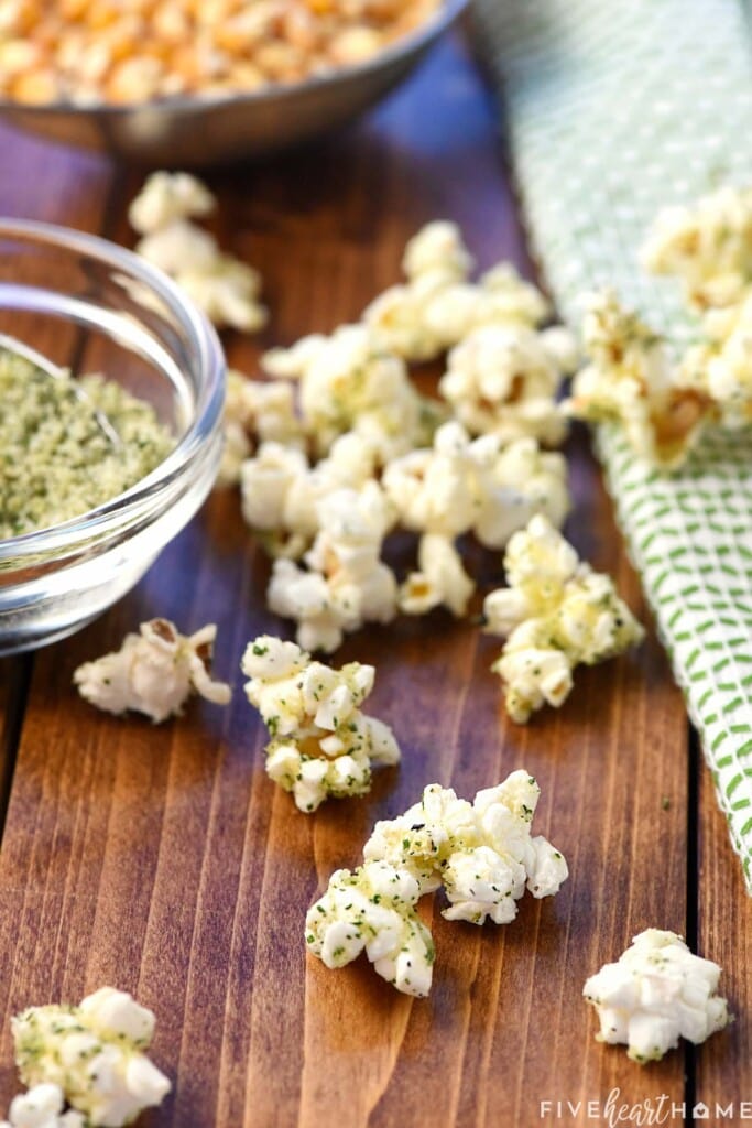 Close-up of Ranch Popcorn Seasoning on pieces of popcorn on table.