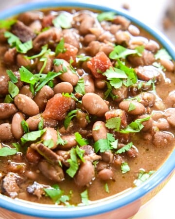 Charro Beans in bowl with cilantro.