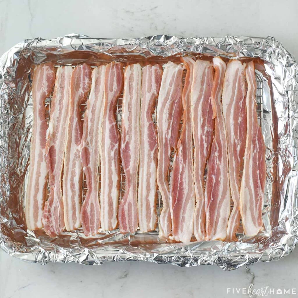 Bacon on rack in pan ready to bake.