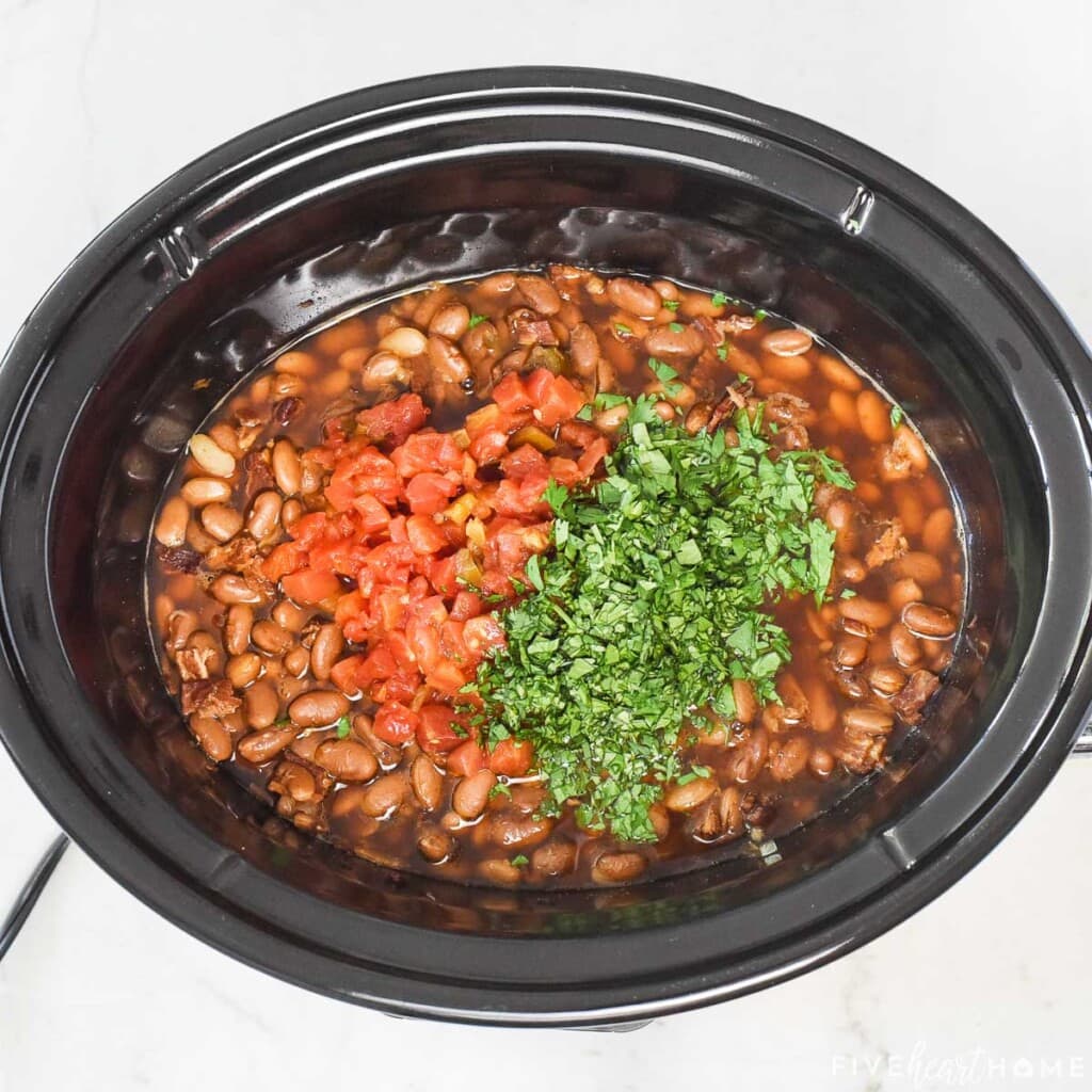 Adding Rotel and cilantro to Charro Beans recipe.