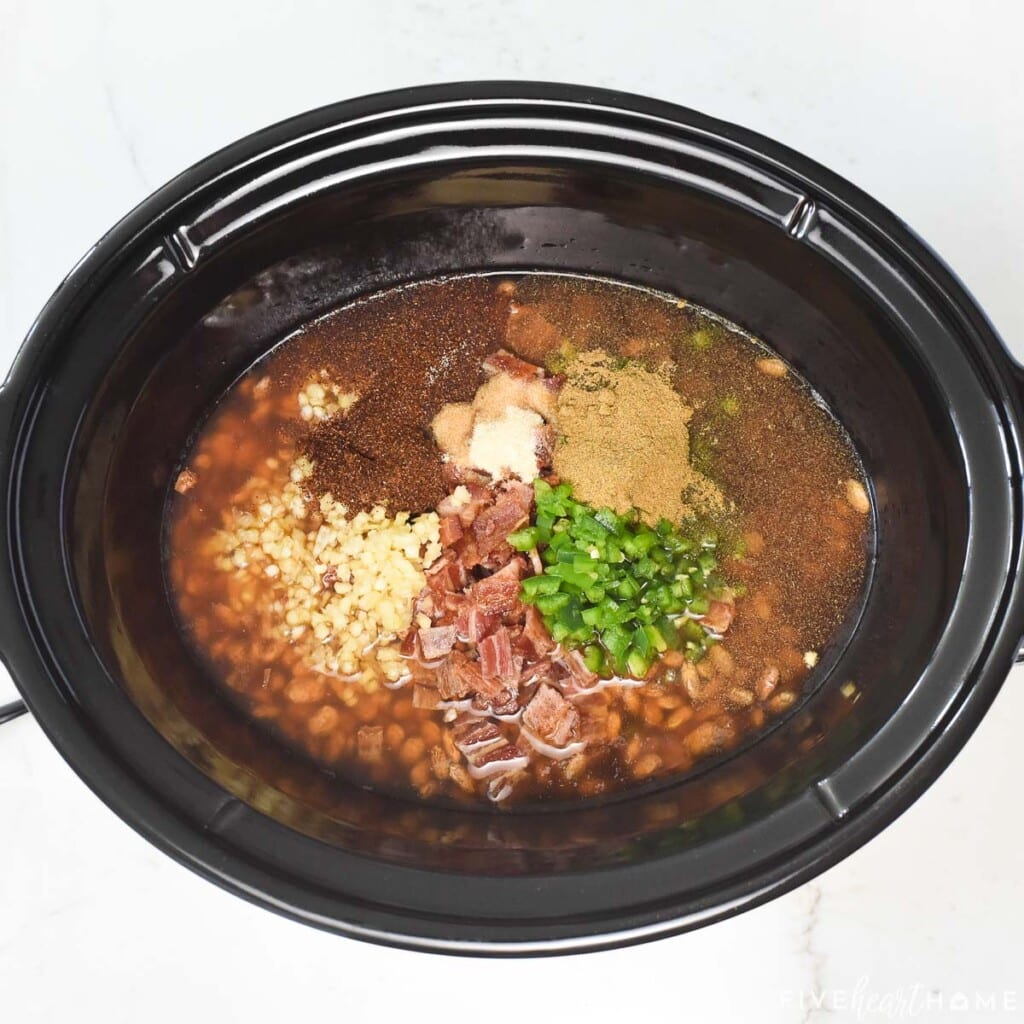 Adding remaining ingredients to Charro Beans in slow cooker.