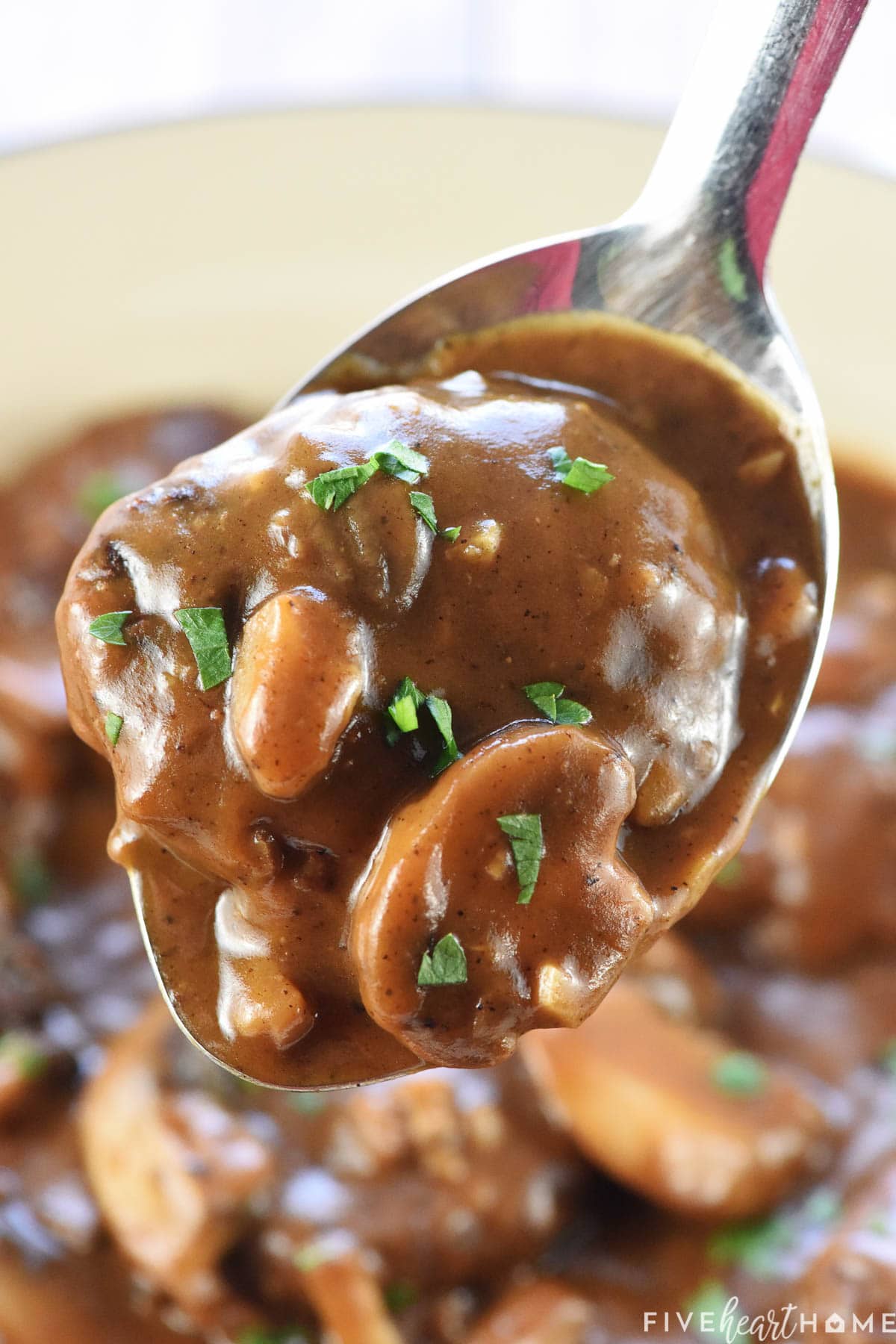 Mushroom Gravy for Hamburger Steak on a serving spoon.