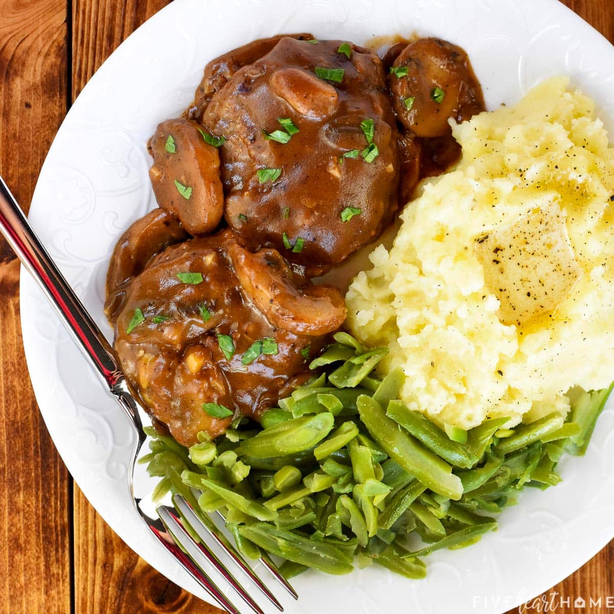 Aerial view of Hamburger Steak with Mushroom Gravy on plate.