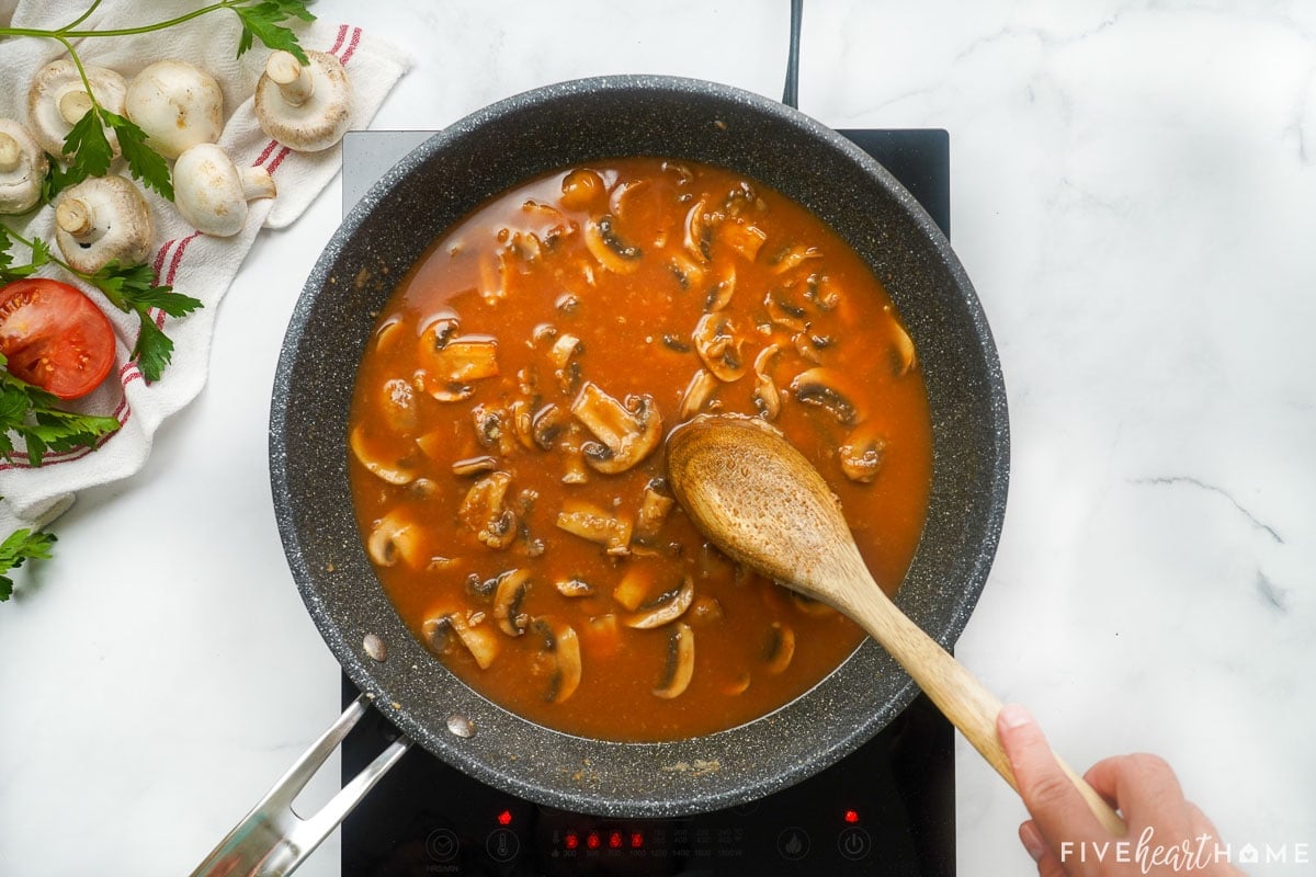 Skillet of mushroom gravy for hamburger steak.